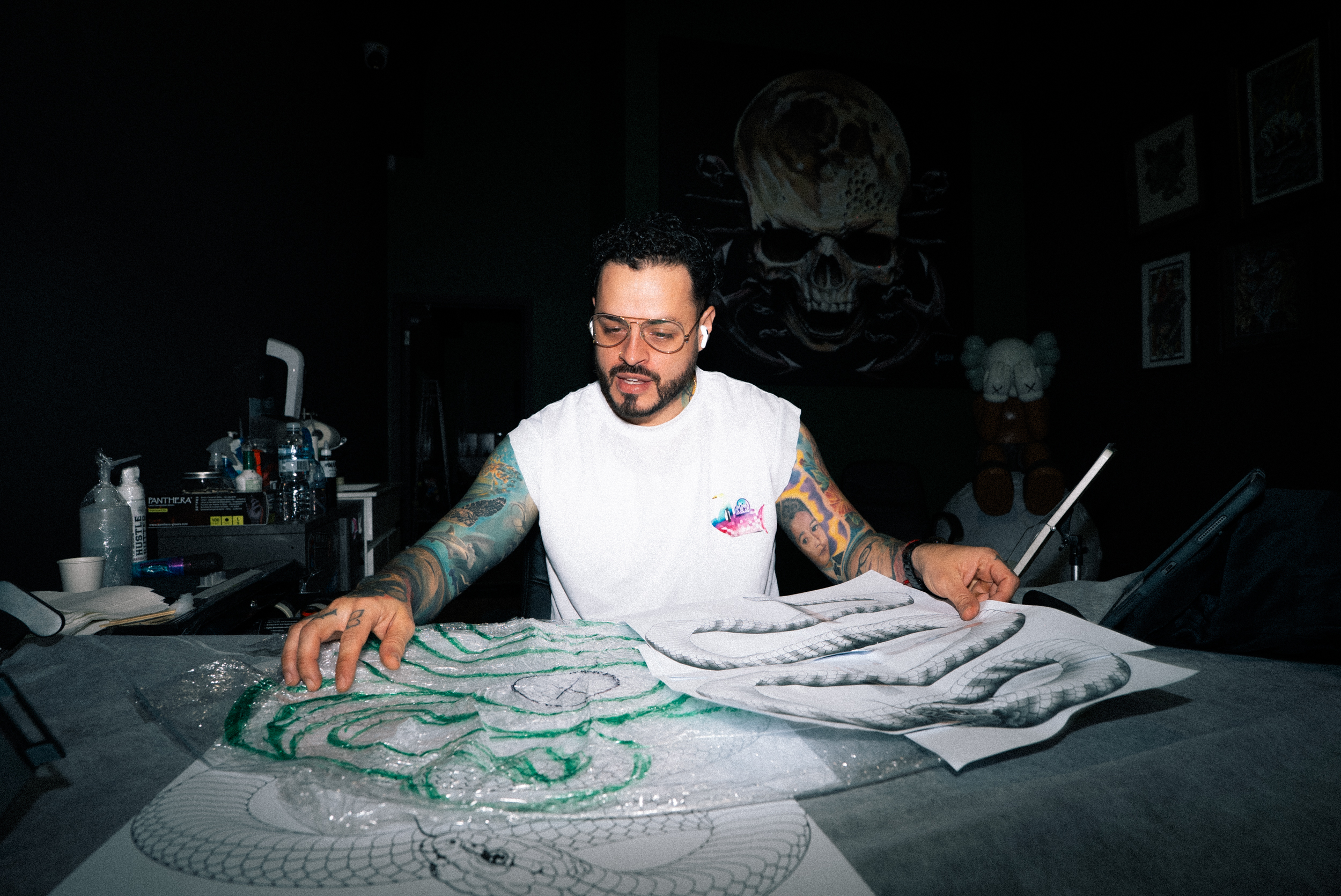 An artist drawing up a design on the floor at Full Moon Tattoo, Prahran